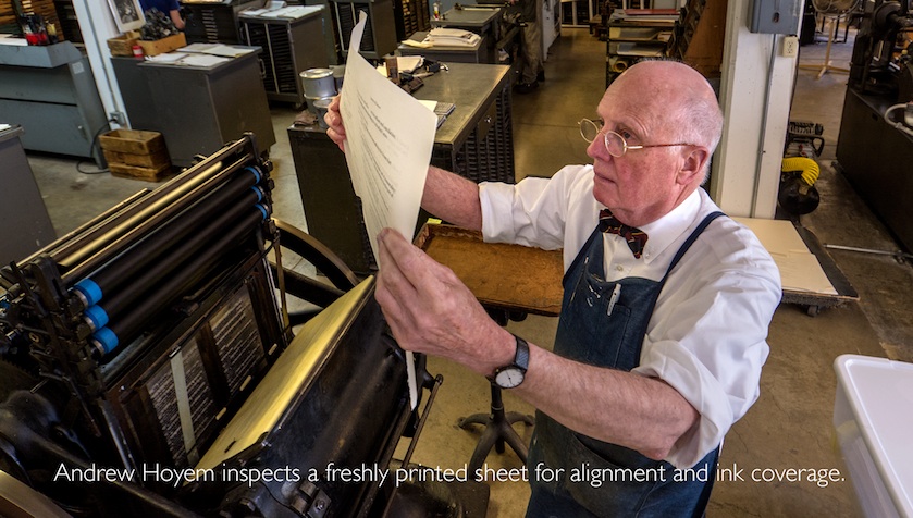Andrew Hoyem inspects a freshly printed sheet for alignment and ink coverage.
